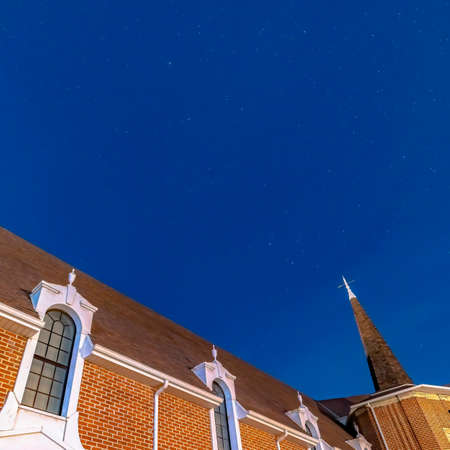 Square Vivid blue sky over a church in Provo Utah with brick wall and arched windowsの写真素材
