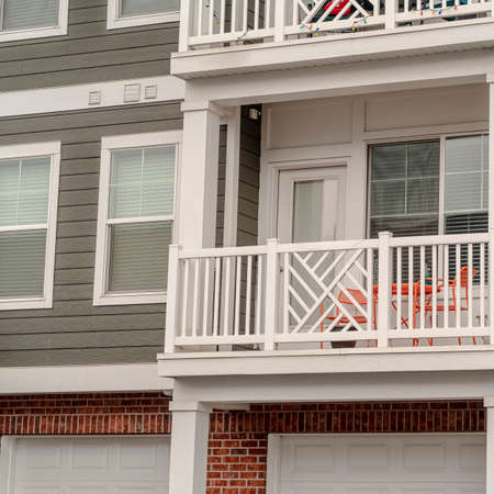 Square Balcony with white iron railing on a modern urban apartment block in close upの写真素材