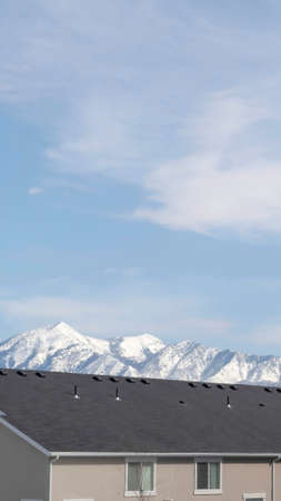 Vertical crop Homes in South Jordan Utah with snowy peak of Wasatch Mountains backgroundの写真素材
