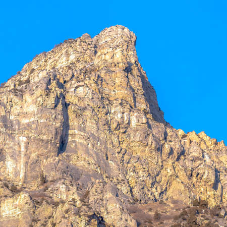 Square frame Precipitous slope of a rocky mountain gainst clear blue sky in Provo Canyon