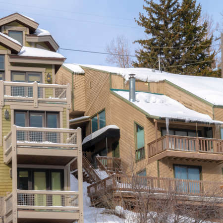 Square frame Snow and icicles on roofs of mountain homes in Park City Utah during winter