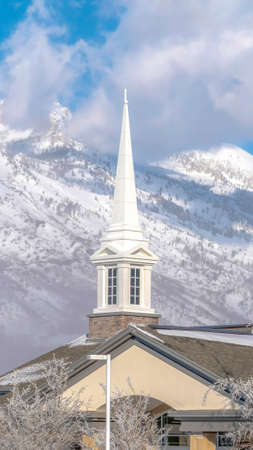 Vertical Magnificent view of snow covered Wasatch Mountain with church in the foreground....