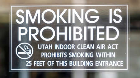 Panorama Clear glass entrance door of a building in Utah with Smoking Is Prohibited signの写真素材