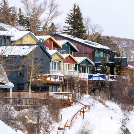 Square crop Residential houses on snowy mountain slope in scenic Park City Utah in winter