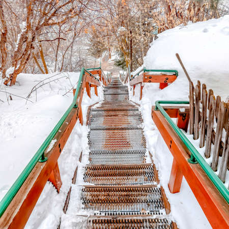 Square Stairs on hill overlooking scenic nature landscape blanketed with snow in winterの写真素材