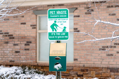 Pet waste sign with dog poop bags reminding people to clean up after their petsの写真素材