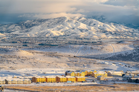 Townhouses apartments and homes against snow covered mountain view in winterの写真素材