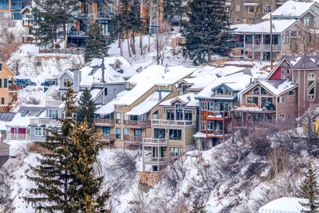 Multi storey luxury homes on a mountain town covered with snow in winterの写真素材