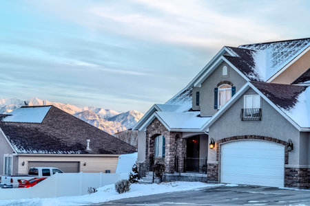 Facade of house with porch and attached garage against glorious mountain viewの写真素材