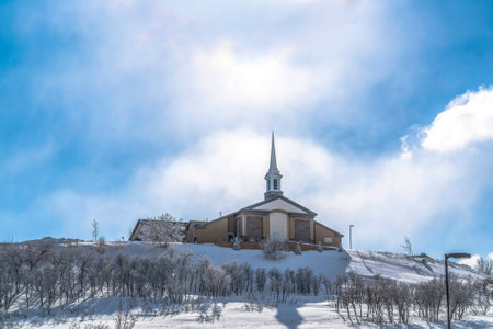 Facade of a church at a scenic neighborhood blanketed with snow in winterの写真素材