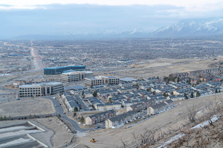 Aerial view of neighborhood town with roads amidst houses and town buildingsの写真素材