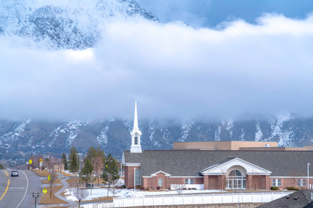 Utah Valley residential community against striking Wasatch Mountain and cloudsの写真素材