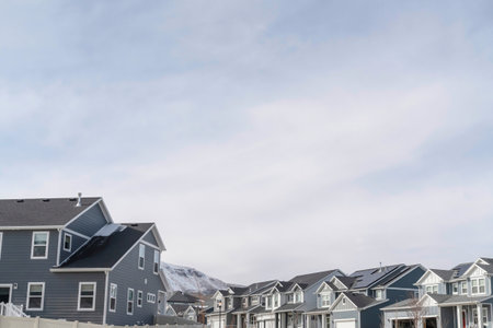 Houses and mountain on a neighborhood landscape with cloudy sky in winterの写真素材