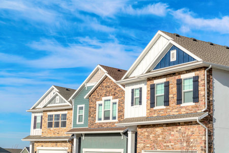 Exterior view of homes with gable roofs stone brick and wooden siding walls