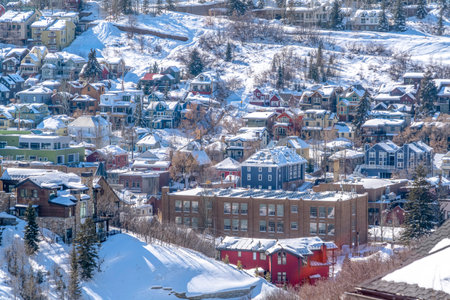 Sunlit neighborhood on a snowy winter mountain setting in scenic Park City Utahの写真素材