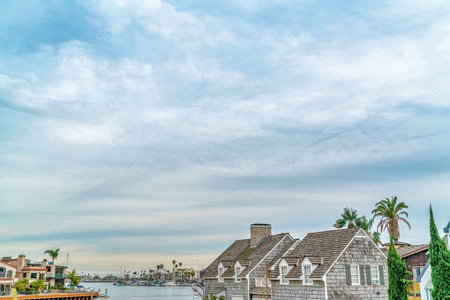 Blue sky and puffy clouds over scenic waterfront neighborhood of Long Beachの写真素材