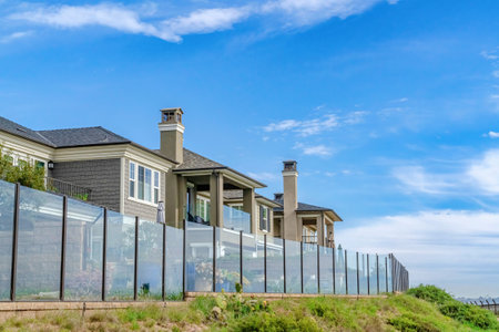 Homes with glass fences and scenic waterfront views in Huntington Beach CAの写真素材