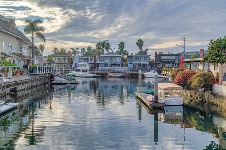 Sunset view in Huntington Beach with boats on private docks of waterfront homes