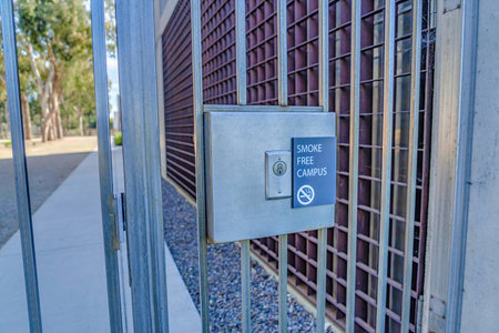 Keyhole and Smoke Free Campus sign on the gate of school in San Diego California