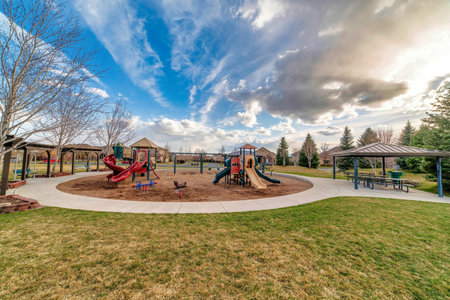 Childrens playground and picnic pavilion at a scenic public neighborhood parkの写真素材