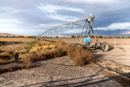 Center-pivot water system irrigation in the middle of a large fieldの写真素材