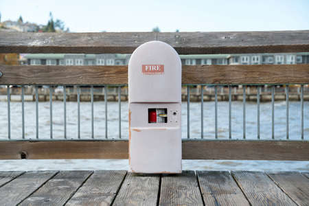 Fire extinguisher inside an arched cabinet on a dock in Tacoma, Washington