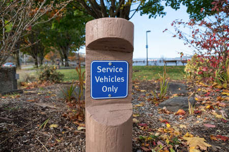 Public signage on a decorative short log post at Tacoma, Washingtonの写真素材