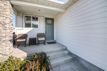 Front porch exterior with stone column post and seasonal decorations