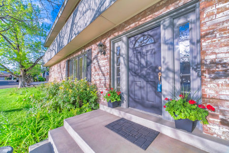 Beautiful house on real estate estate with lockbox on the handle of front doorの写真素材