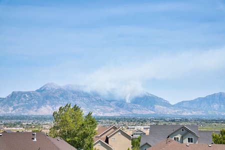 Smoke from wildfire in the Wasatch mountains senn from houses in Utah Valleyの写真素材