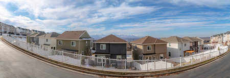 Two-storey houses with same style at Draper, Utah with a clear sky and mountain range backgroundの写真素材