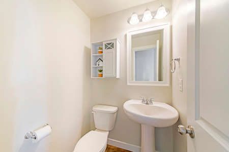 Interior of a white powder room with minimalist design
