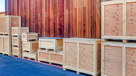 Pano Crate container boxes against exterior wall and ventilator window of building