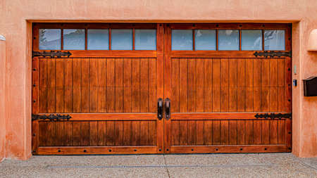 Pano Home with balcony above garage against peach wall in San Diego California