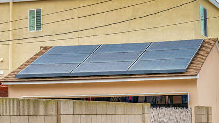 Pano Solar panels at the roof of house in Long Beach California against cloudy sky