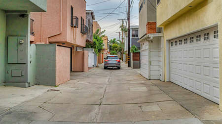 Pano Car on a narrow neighborhood street along houses in Long Beach Californiaの写真素材