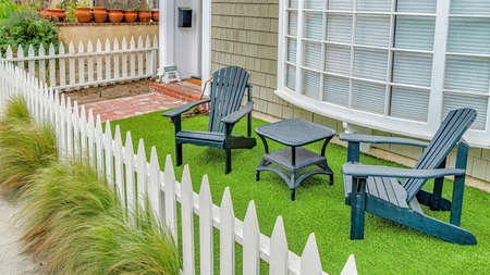 Pano Front yard of house with furniture against curved bay window in Long Beach CA