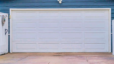 Pano Garage with gable roof over white door and gray wall in San Diego Californiaの写真素材