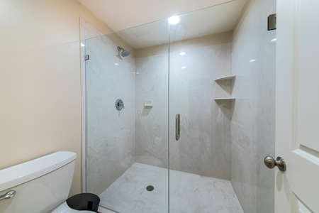 Interior of a bathroom with frameless shower stallの写真素材