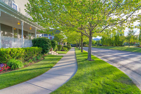 Sidewalk at the front of houses with traditional designs at Daybreak, Utahの写真素材