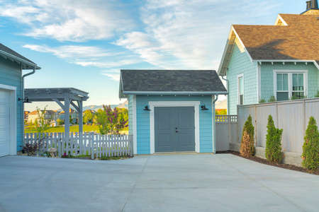 Light blue storage shed outside a house at Daybreak, Utahの写真素材