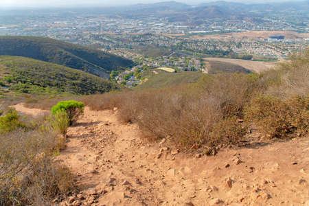 Rough dirt hiking trail in the middle of bushes at Double Peak Park, San Marcos, Californiaの写真素材