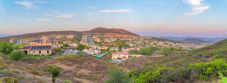 Panoramic view of a fenced community in San Diego, California. Residential area in the middle of the mountains with trees and roads outdoors.の写真素材