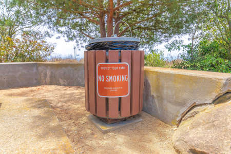 Public trash container with cover and no smoking sign at Laguna Niguel in California
