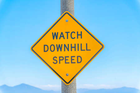 Diagonal roadsign with watch downhill speed on a metal post at Laguna Niguel, Californiaの写真素材