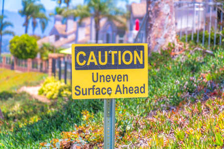Yellow caution signage on a metal post in Laguna Niguel in Californiaの写真素材