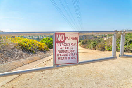 No parking sign on a metal road gate barrier at San Diego, California