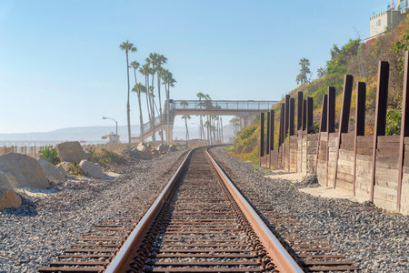 Train tracks with footbridge at San Clemente, Orange County, Californiaの写真素材