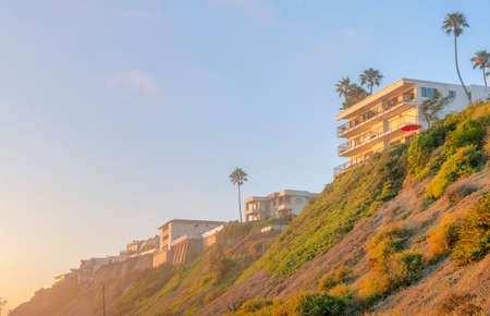 Flat buildings on top of a mountain against the sunset sky at San Clemente, Californiaの写真素材