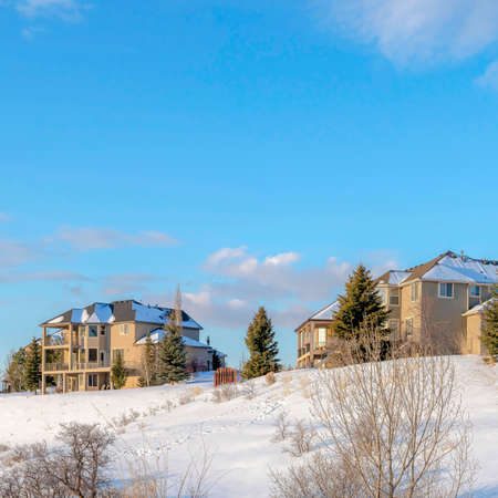Square White puffy clouds Large residential area on top of a snowy hill at Draper, Utahの写真素材